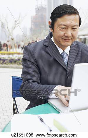Close-up of a businessman using a laptop View Large Photo Image Stock Photo - Close-up of a businessman using a laptop. Fotosearch
