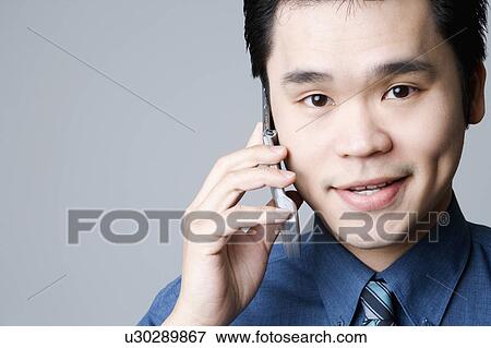 Portrait of a businessman talking on a mobile phone View Large Photo Image Stock Photo - Portrait of a businessman talking on a mobile phone. Fotosearch