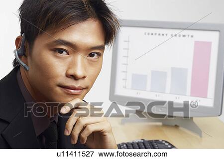 Portrait of a businessman thinking in front of a progress report View Large Photo Image Stock Photo - Portrait of a businessman thinking in front of a progress report. Fotosearch
