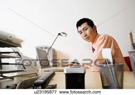 Portrait of a businessman using a laptop View Large Photo Image Stock Photo - Portrait of a businessman using a laptop. Fotosearch