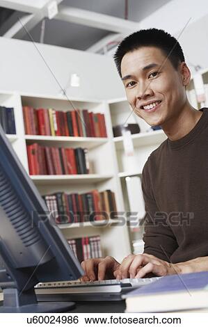 Portrait of a businessman using a computer View Large Photo Image Stock Photograph - Portrait of a businessman using a computer. Fotosearch