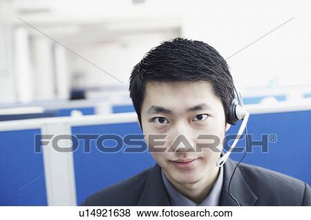 Portrait of a businessman wearing a headset View Large Photo Image Stock Photo - Portrait of a businessman wearing a headset. Fotosearch