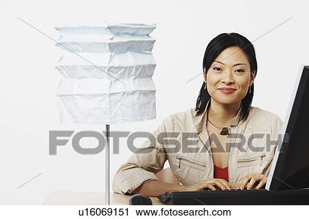 Stock Image - Portrait of a businesswoman using a computer. Fotosearch