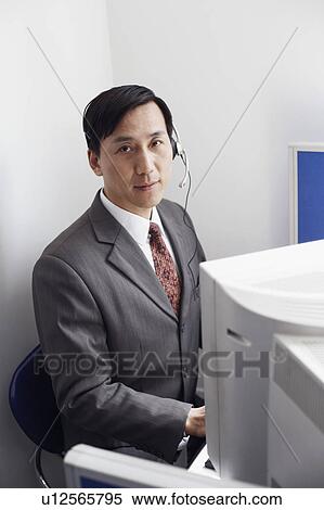 Portrait of a customer service representative working on a computer View Large Photo Image Stock Photography - Portrait of a customer service representative working on a computer. Fotosearch