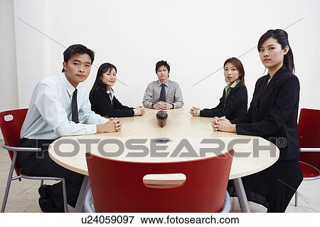 Stock Photo - Portrait of business executives sitting in a board room. Fotosearch