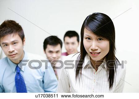 Stock Image - Portrait of business executives standing together. Fotosearch