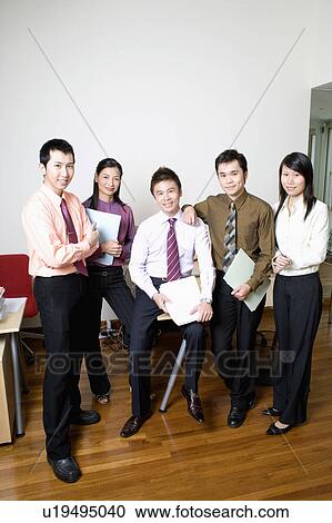 Portrait of five business executives standing and smiling together View Large Photo Image Stock Image - Portrait of five business executives standing and smiling together. Fotosearch