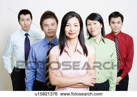 Stock Photograph - Portrait of five business executives standing together and smiling. Fotosearch