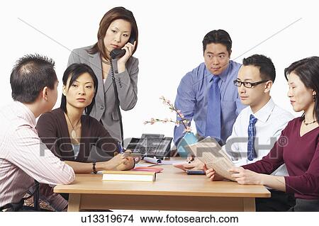 Picture - Three businessmen and three businesswomen in a meeting. Fotosearch