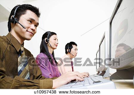 Three customer service representatives working on computers View Large Photo Image Stock Photo - Three customer service representatives working on computers. Fotosearch