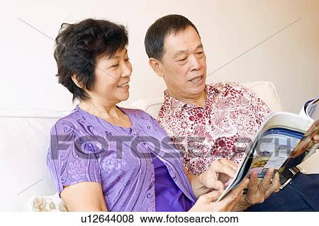 Close-up of a senior man and a mature woman reading a magazine View Large Photo Image Stock Photo - Close-up of a senior man and a mature woman reading a magazine. Fotosearch