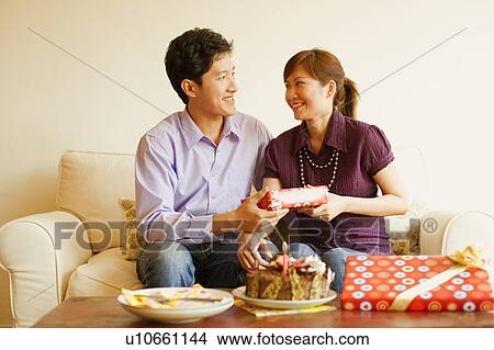 Close-up of a young couple smiling View Large Photo Image Picture - Close-up of a young couple smiling. Fotosearch