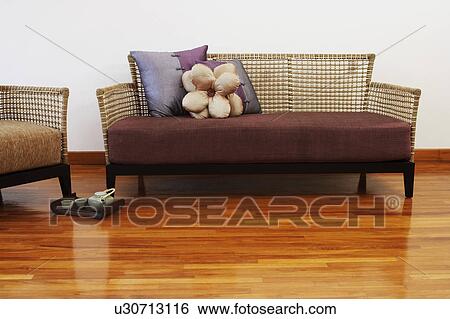 Couch and an armchair on a hardwood floor View Large Photo Image Stock Photograph - Couch and an armchair on a hardwood floor. Fotosearch