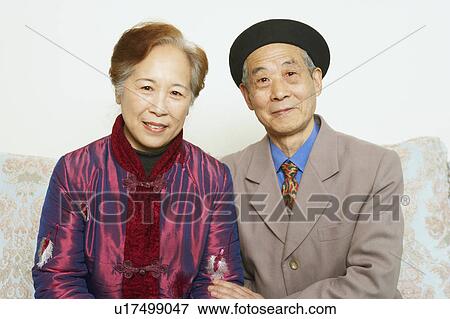 Portrait of a senior man sitting on a couch with a mature woman View Large Photo Image Stock Photo - Portrait of a senior man sitting on a couch with a mature woman. Fotosearch