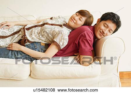 Side profile of a young couple sleeping back to back on a couch View Large Photo Image Stock Photo - Side profile of a young couple sleeping back to back on a couch. Fotosearch