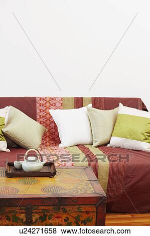Stock Photo - Teapot and a tea cup with a tray on a trunk. Fotosearch