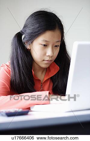 Stock Photograph - Close-up of a girl using a laptop. Fotosearch