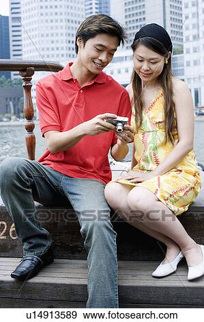 Close-up of a young couple looking at a digital camera View Large Photo Image Stock Photo - Close-up of a young couple looking at a digital camera. Fotosearch