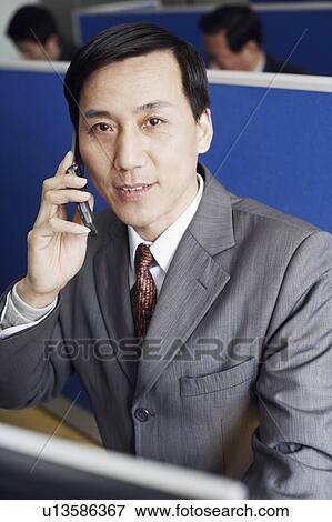 Portrait of a businessman talking on a mobile phone View Large Photo Image Stock Photo - Portrait of a businessman talking on a mobile phone. Fotosearch