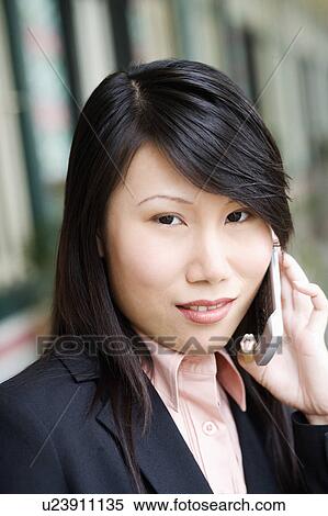 Portrait of a businesswoman talking on a mobile phone View Large Photo Image Stock Photography - Portrait of a businesswoman talking on a mobile phone. Fotosearch