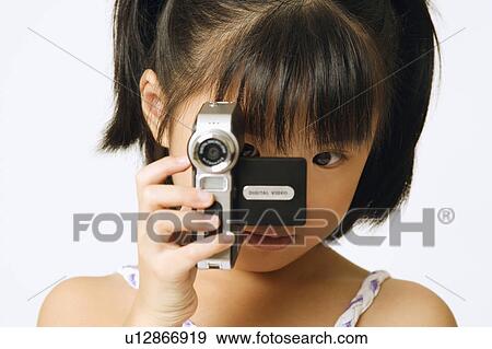 Stock Photo - Portrait of a girl holding a home video camera. Fotosearch