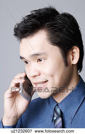 Close-up of a businessman talking on a mobile phone View Large Photo Image Stock Photo - Close-up of a businessman talking on a mobile phone. Fotosearch