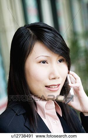 Close-up of a businesswoman talking on a mobile phone View Large Photo Image Stock Image - Close-up of a businesswoman talking on a mobile phone. Fotosearch