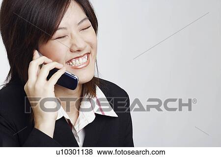 Close-up of a businesswoman talking on a mobile phone View Large Photo Image Stock Photo - Close-up of a businesswoman talking on a mobile phone. Fotosearch