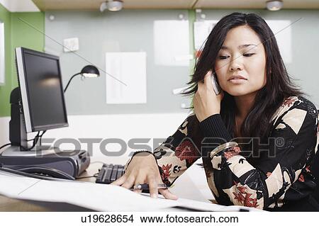 Close-up of a businesswoman using a mobile phone View Large Photo Image Picture - Close-up of a businesswoman using a mobile phone. Fotosearch