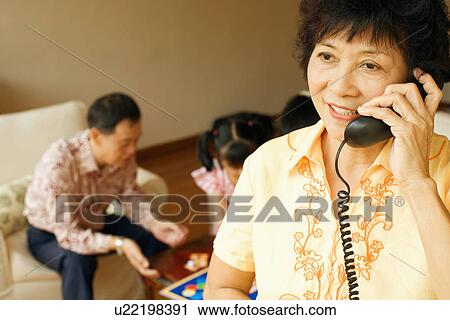 Close-up of a mature woman talking on the telephone View Large Photo Image Stock Image - Close-up of a mature woman talking on the telephone. Fotosearch