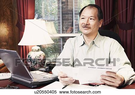 Close-up of a senior man holding a letter View Large Photo Image Stock Photography - Close-up of a senior man holding a letter. Fotosearch