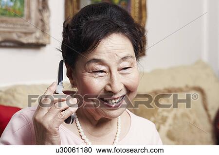 Close-up of a senior woman talking on a mobile phone View Large Photo Image Stock Image - Close-up of a senior woman talking on a mobile phone. Fotosearch