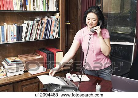 Stock Photo - Mature woman talking on the telephone. Fotosearch