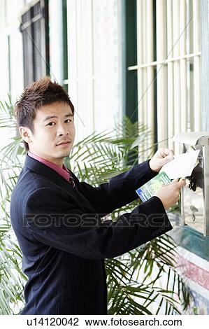 Portrait of a businessman dropping mails into a mailbox View Large Photo Image Stock Image - Portrait of a businessman dropping mails into a mailbox. Fotosearch