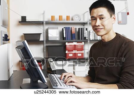 Portrait of a businessman using a computer View Large Photo Image Stock Photography - Portrait of a businessman using a computer. Fotosearch
