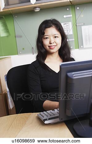 Portrait of a businesswoman using a computer smiling View Large Photo Image Stock Photo - Portrait of a businesswoman using a computer smiling. Fotosearch