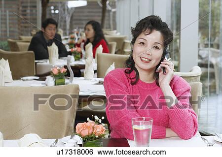 Portrait of a mature woman using a mobile phone View Large Photo Image Stock Photograph - Portrait of a mature woman using a mobile phone. Fotosearch