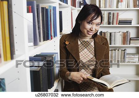 Portrait of a businesswoman holding a book smiling View Large Photo Image Stock Image - Portrait of a businesswoman holding a book smiling. Fotosearch