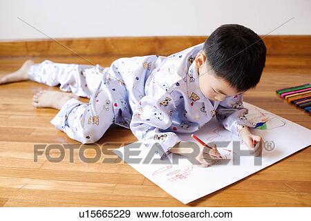 Stock Photo - Close-up of a boy drawing on paper. Fotosearch