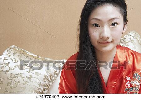 Stock Image - Close-up of a young woman grinning. Fotosearch