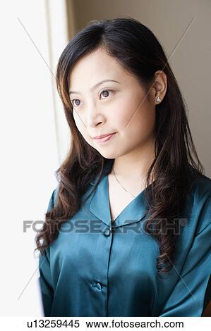 Close-up of a young woman looking away View Large Photo Image Stock Photography - Close-up of a young woman looking away. Fotosearch