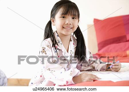 Stock Photograph - Portrait of a girl drawing on paper. Fotosearch