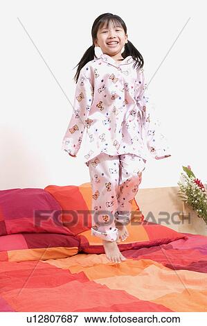 Stock Photo - Portrait of a girl standing on one leg. Fotosearch