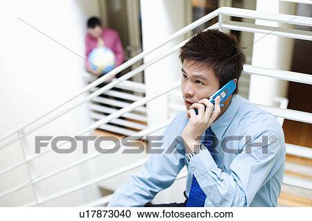 Close-up of a businessman talking on a mobile phone View Large Photo Image Stock Image - Close-up of a businessman talking on a mobile phone. Fotosearch