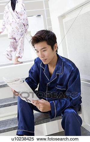 Close-up of a mid adult man reading a newspaper View Large Photo Image Stock Photography - Close-up of a mid adult man reading a newspaper. Fotosearch