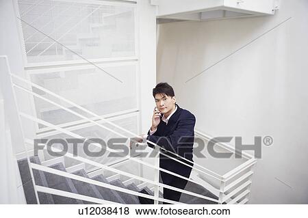 Portrait of a businessman talking on a mobile phone View Large Photo Image Stock Photo - Portrait of a businessman talking on a mobile phone. Fotosearch