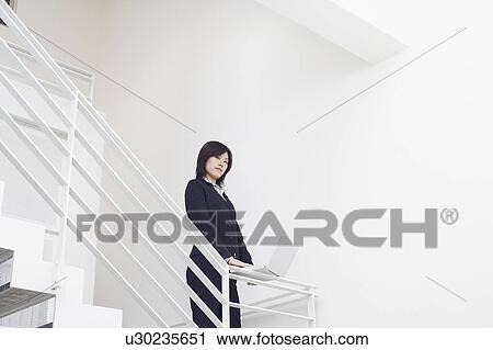 Portrait of a businesswoman using a laptop on the staircase View Large Photo Image Stock Image - Portrait of a businesswoman using a laptop on the staircase. Fotosearch