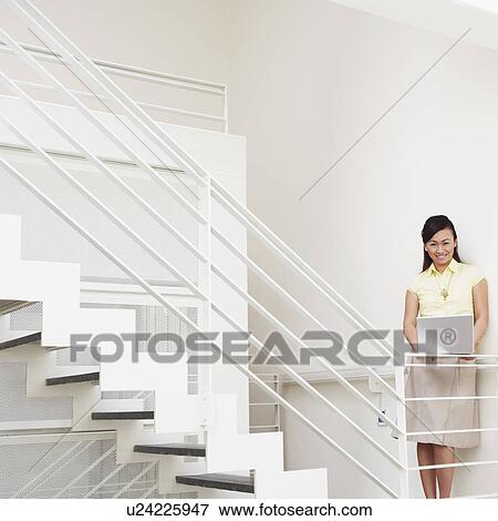 Stock Photo - Portrait of a young woman smiling. Fotosearch