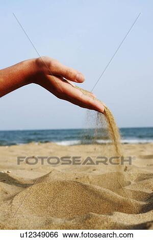 Stock Photograph - sand, issue, hand, fistful, castle, fact, beach. Fotosearch