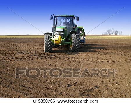 Tractor and farmer in the field View Large Photo Image Stock Photograph - Tractor and farmer in the field. Fotosearch